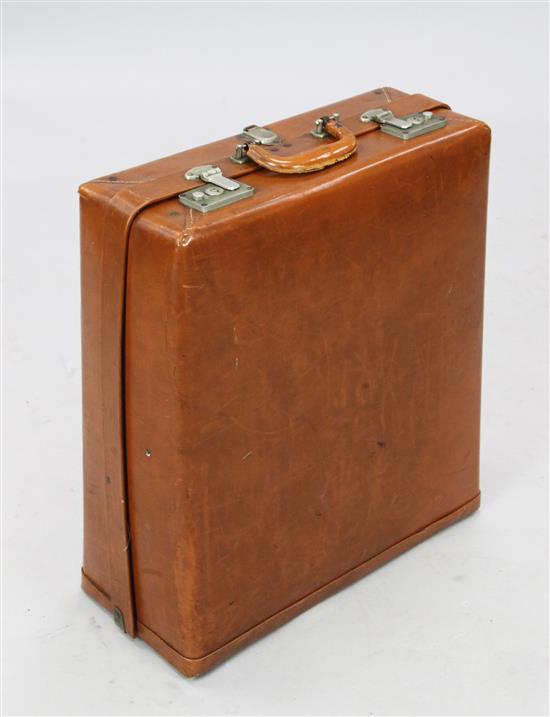 A Rev-Robe Patent tan leather suitcase, H,1ft 10in.